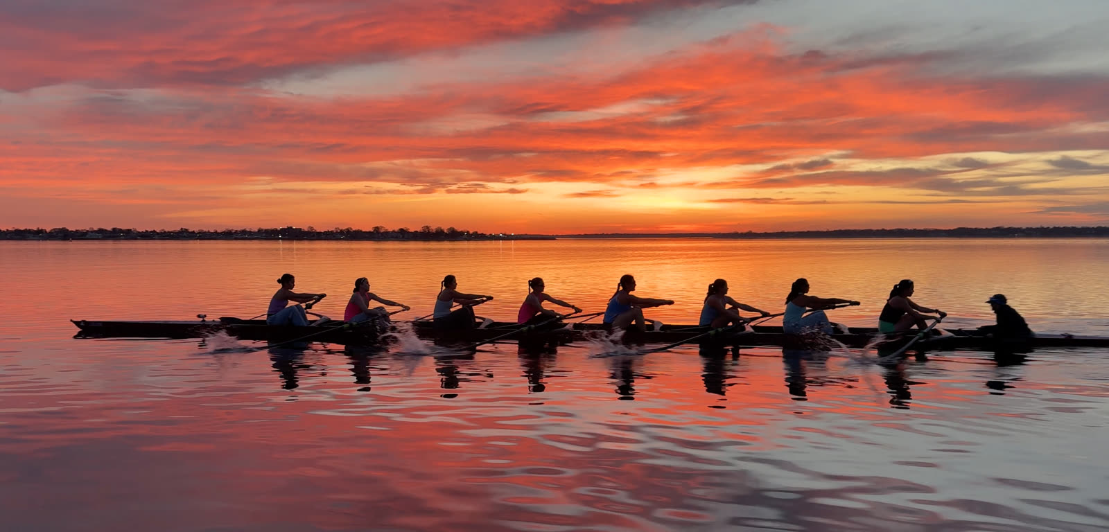 U19 eight driving through a sunset row